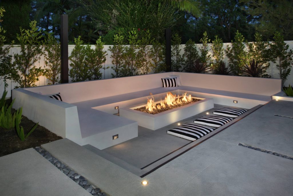 Patio - large modern backyard concrete patio idea in Orange County with a fire pit and a gazebo