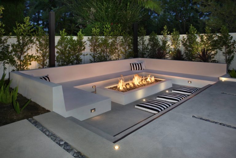 Patio - large modern backyard concrete patio idea in Orange County with a fire pit and a gazebo