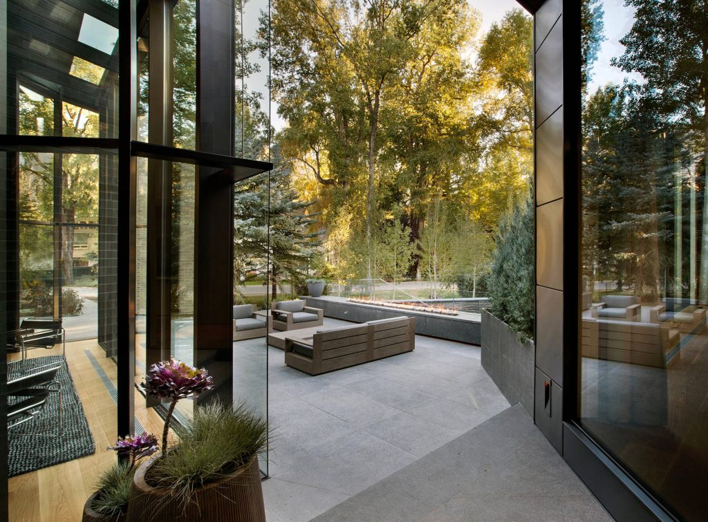 Inspiration for a contemporary backyard patio remodel in Denver with a fire pit and no cover