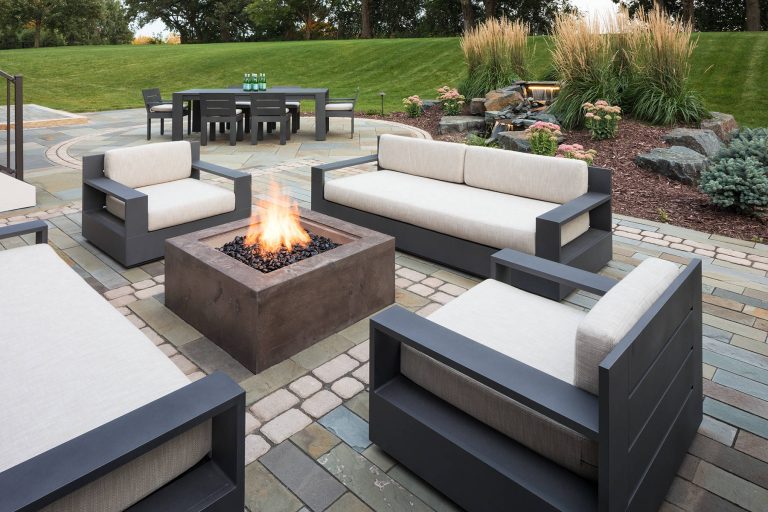 Example of a mid-sized trendy backyard concrete paver patio design in Minneapolis with a fire pit and no cover