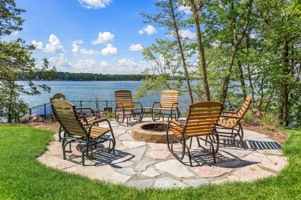 Patio - rustic backyard brick patio idea in Minneapolis with a fire pit and no cover