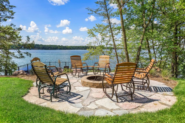 Patio - rustic backyard brick patio idea in Minneapolis with a fire pit and no cover
