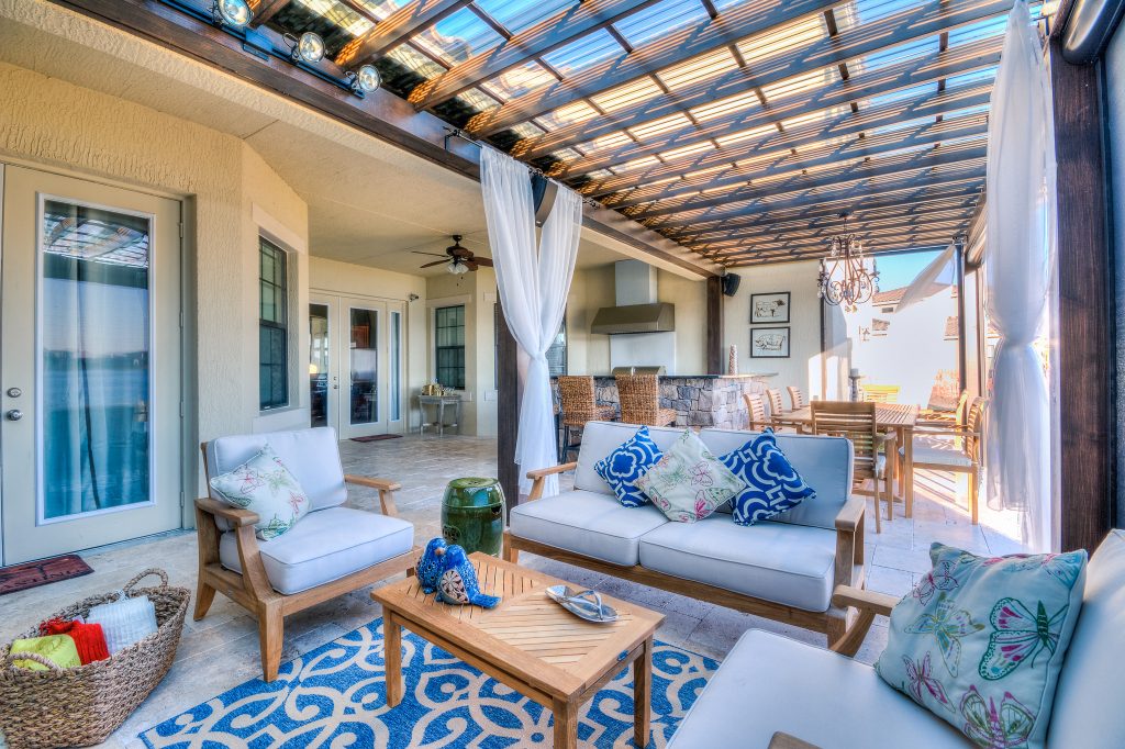 Patio - large transitional backyard stone patio idea in Orlando with a fire pit and a roof extension