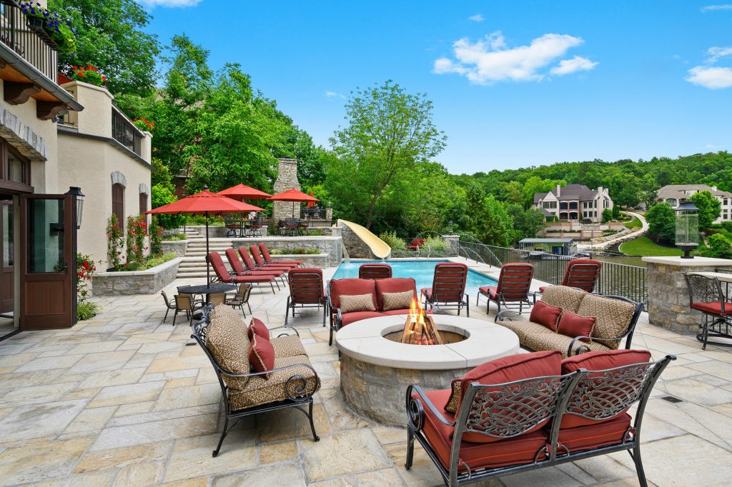 Patio - huge mediterranean backyard patio idea in Kansas City with a fire pit and no cover