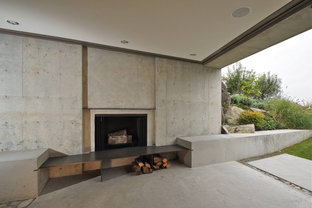Inspiration for a contemporary concrete patio remodel in Seattle with a fire pit and a roof extension