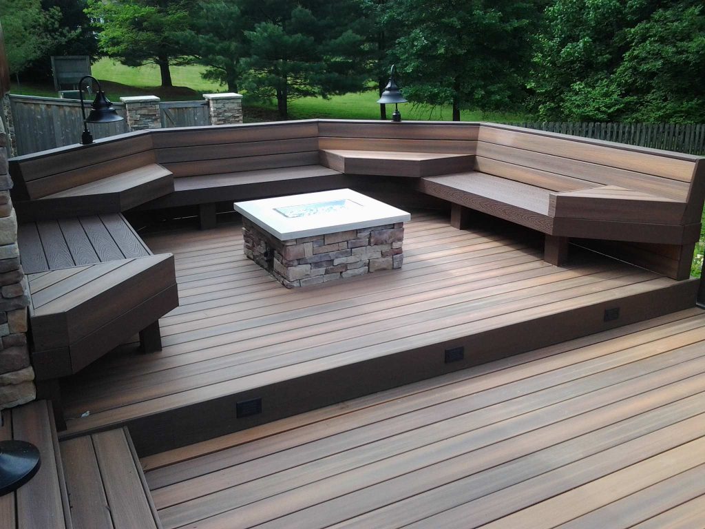 Fiberon decking, Twin Eagles grill center, low voltage and accent lighting, floating tables and pit group seating around firepit by DHM Remodeling