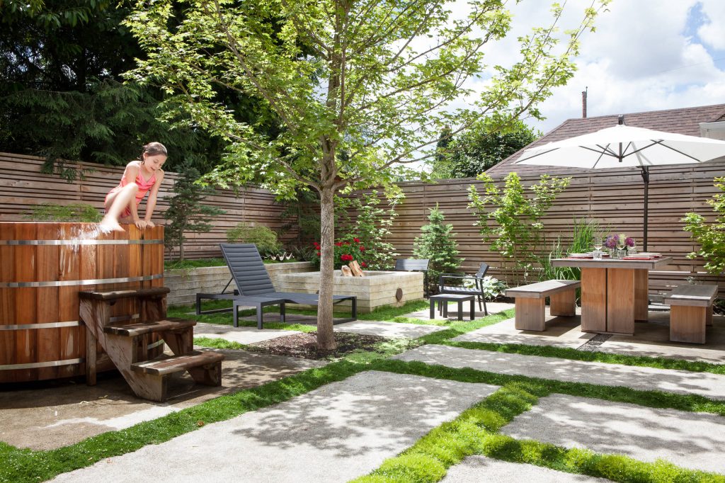 This project reimagines an under-used back yard in Portland, Oregon, creating an urban garden with an adjacent writer’s studio. Taking inspiration from Japanese precedents, we conceived of a paving scheme with planters, a cedar soaking tub, a fire pit, and a seven-foot-tall cedar fence. A maple tree forms the focal point and will grow to shade the yard. Board-formed concrete planters house conifers, maples and moss, appropriate to the Pacific Northwest climate. Photo: Anna M Campbell: annamcampbell.com