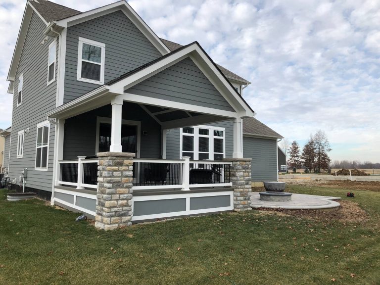 This gorgeous open porch design is brought to life with low-maintenance TimberTech Terrain decking in Silver Maple, which beautifully complements the home’s exterior finish! The steps are matching TimberTech product with riser lights. The railing is also a low-maintenance vinyl and powder coated aluminum combined with a TimberTech top rail, which will have this family enjoying their space – not performing yearly maintenance! The substantial stacked stone columns are the shining stars of this covered porch design in beautiful muted grey and brown tones. We provided matching roofing and siding on the exterior of the gable, so the new porch appears an original extension of the home – not an afterthought. by Archadeck - Columbus | Outdoor Photos | Porch | Landscaping | Landscape Design | Outdoor Living Space | Porch Design Ideas | Outdoor Living Space Ideas | Backyard Design