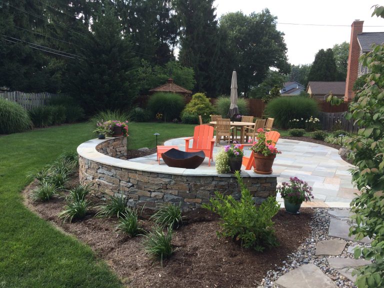Patio - large traditional backyard stone patio idea in Philadelphia with a fire pit and no cover