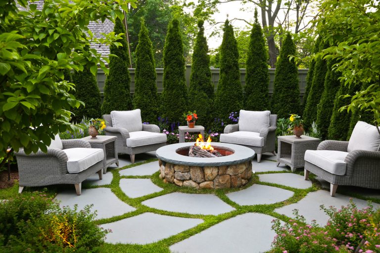 Elegant backyard patio photo in Boston with a fire pit and no cover