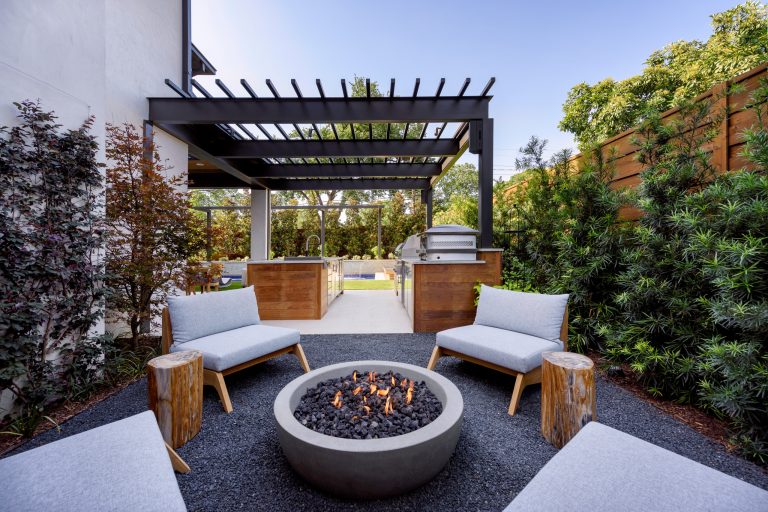 Inspiration for a mid-sized contemporary backyard patio remodel in Dallas with a fire pit and a roof extension