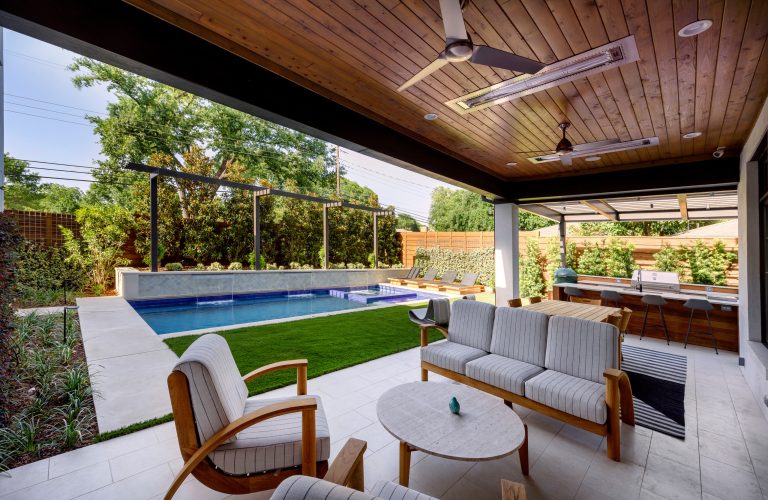 Inspiration for a mid-sized contemporary backyard patio remodel in Dallas with a fire pit and a roof extension