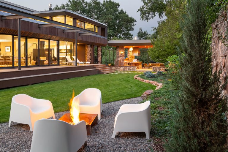 K. Dakin Design won the 2018 CARE award from the Custom Builder and Remodeler Council of Denver for the reimagination of the landscape around this classic organic-modernist home designed by Charles Haertling. The landscape design is inspired by the original home and it’s materials, especially the distinct, clean lines of the architecture and the natural, stone veneer found on the house and landscape walls. The outlines of garden beds, a small patio and a water feature reiterate the home’s straight walls juxtaposed against rough, irregular stone facades and details. This sensitivity to the architecture is clearly seen in the triangular shapes balanced with curved forms.

The clients, a couple with busy lives, wanted a simple landscape with lawn for their dogs to fetch balls. The amenities they desired were a spa, vegetable beds, fire pit, and a water feature. They wanted to soften the tall, site walls with plant material. All the material, such as the discarded, stone veneer and left-over, flagstone paving was recycled into new edging around garden areas, new flagstone paths, and a water feature. The front entry walk was inspired by a walkway at Gunnar Asplund’s cemetary in Sweden. All plant material, aside from the turf, was low water, native or climate appropriate.

Photo credit: Michael de Leon by K. Dakin Design Inc. | Fire Pits|Backyard Design|Outdoor Living Spaces|Landscape Design|Backyard Ideas|Landscaping|Landscaping Ideas|Landscape Installation|Fire Feautures|Fire Pit