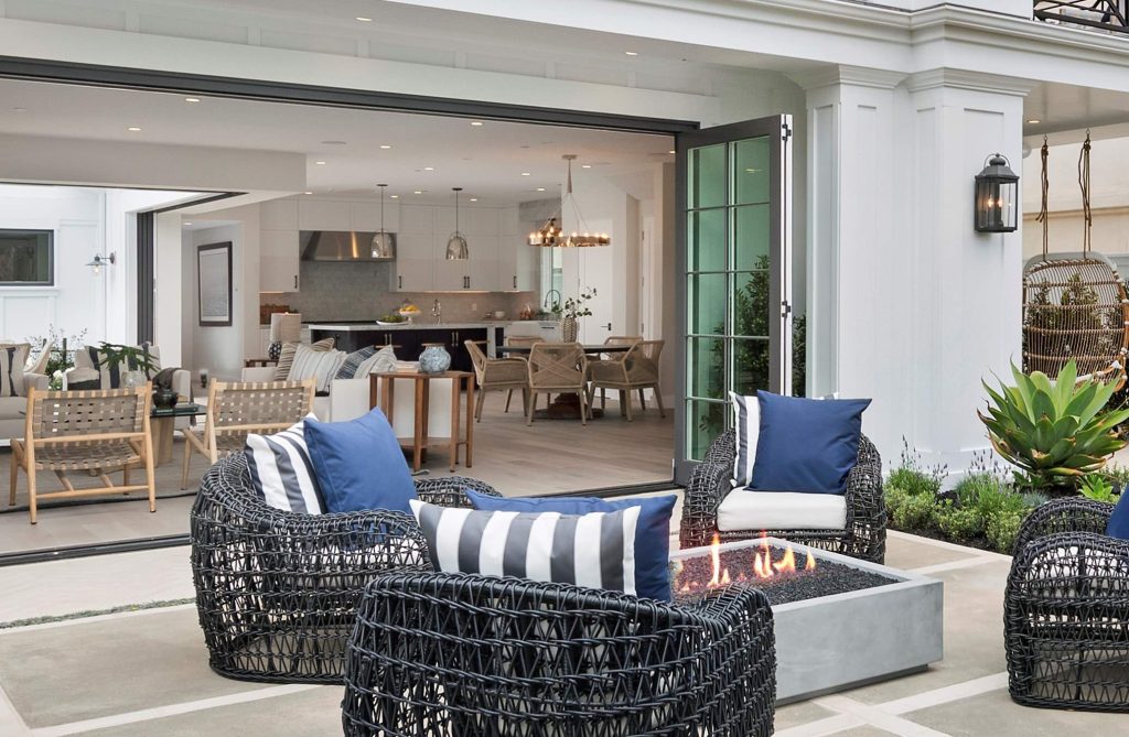 Large beach style front yard concrete patio photo in Orange County with a fire pit and no cover