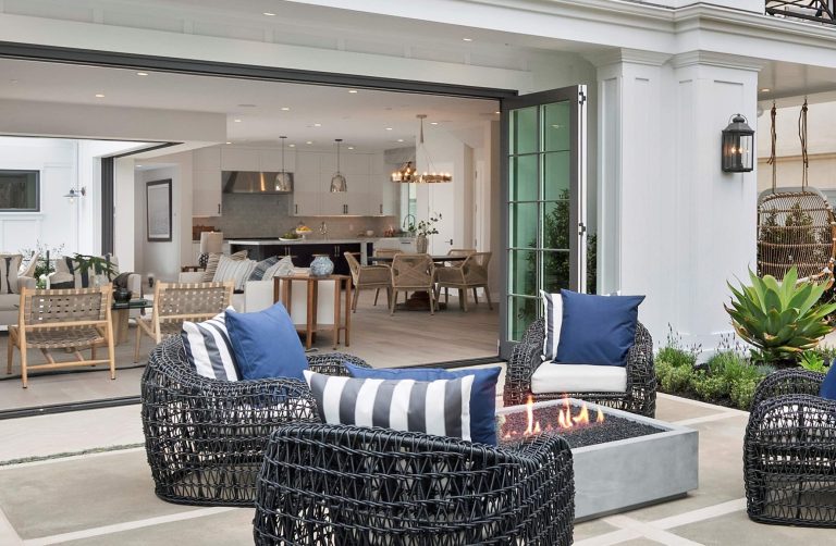 Large beach style front yard concrete patio photo in Orange County with a fire pit and no cover