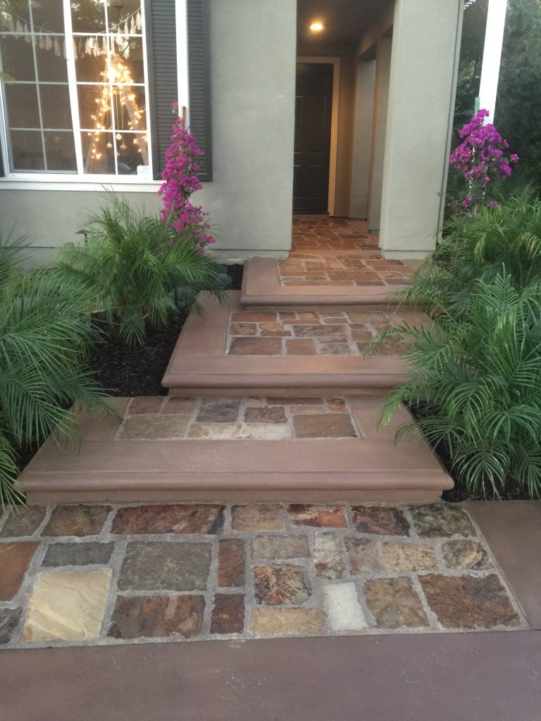 natural stone front entry with concrete coping and steps