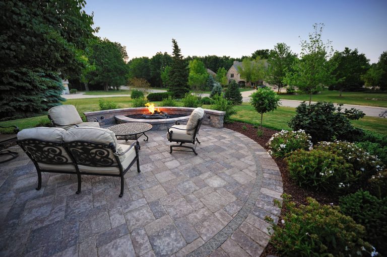 A simple circular patio provides ample room for entertainment, yet fits into the existing landscape. A header border of Stonehenge Sierra pavers leads into an Olde Quarry Sierra seat wall.