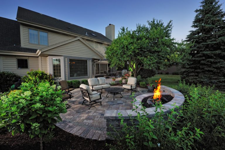 The patio and fire pit align with the kitchen and dining area of the home and flows outward from the redone existing deck.