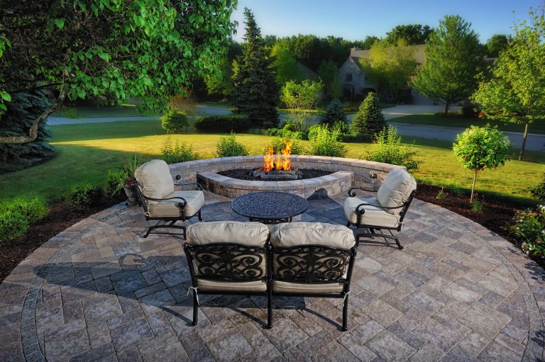 The fire pit and patio are on a central axis from the kitchen and take advantage of an existing planting bed which was added on to previously.