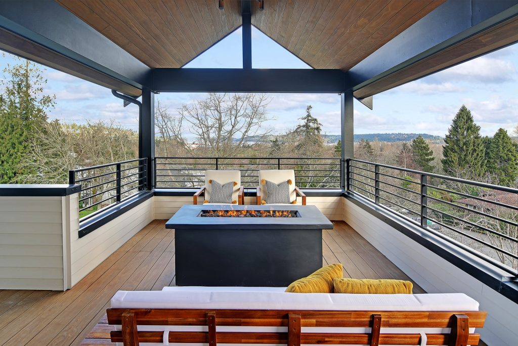 Mid-sized danish deck photo in Seattle with a fire pit and a roof extension