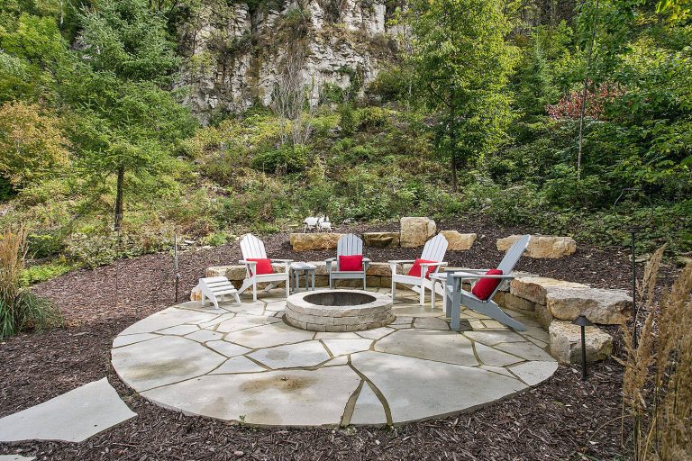 Inspiration for a small coastal backyard stone patio remodel in Other with a fire pit and no cover