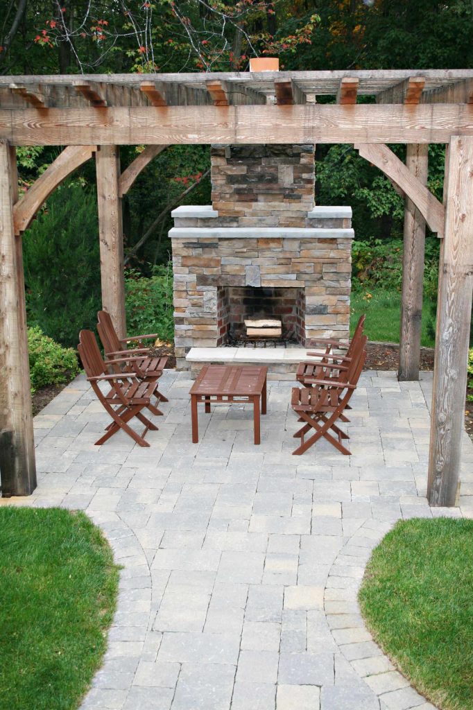 Patio - traditional patio idea in Grand Rapids with a fire pit and a pergola