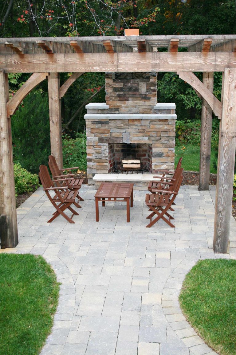 Patio - traditional patio idea in Grand Rapids with a fire pit and a pergola
