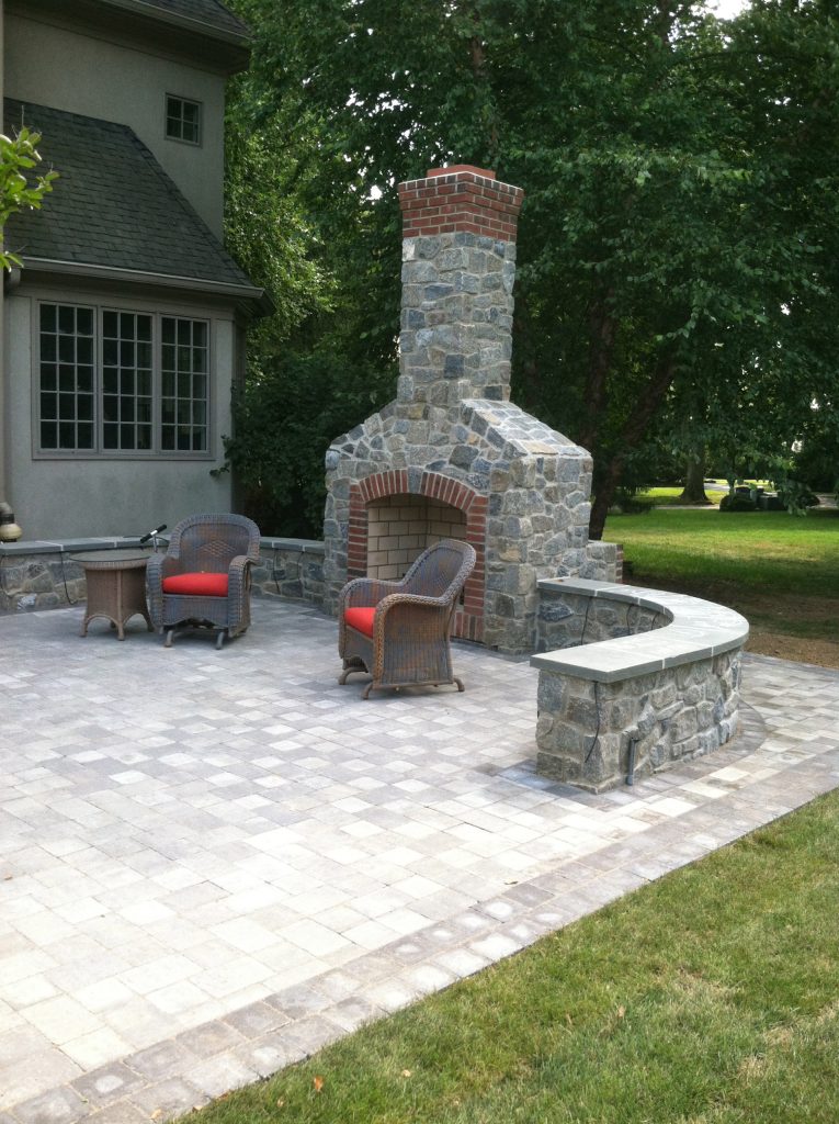Inspiration for a large rustic backyard concrete paver patio remodel in Wilmington with a fire pit and no cover