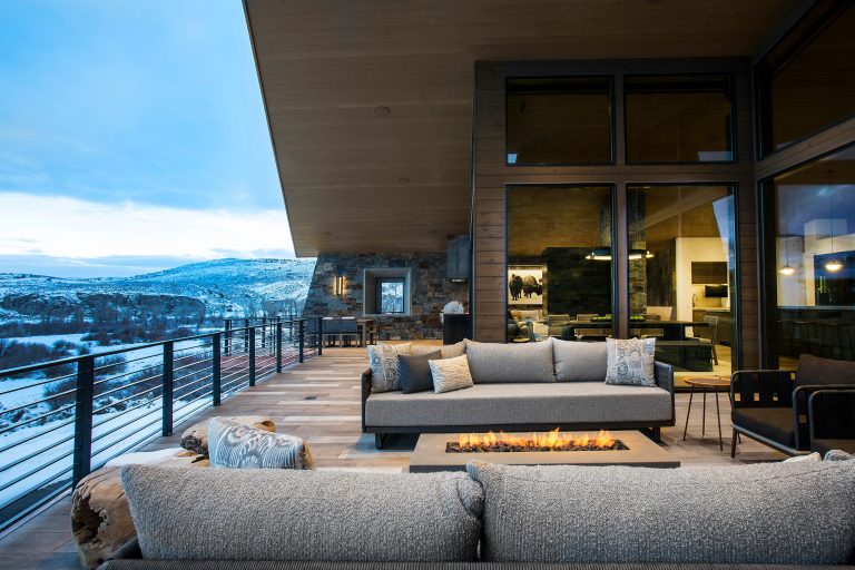 Inspiration for a rustic deck remodel in Chicago with a fire pit and a roof extension