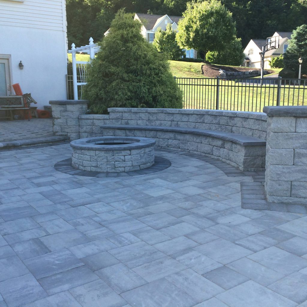 Inspiration for a large timeless backyard stone patio remodel in Other with a fire pit and no cover