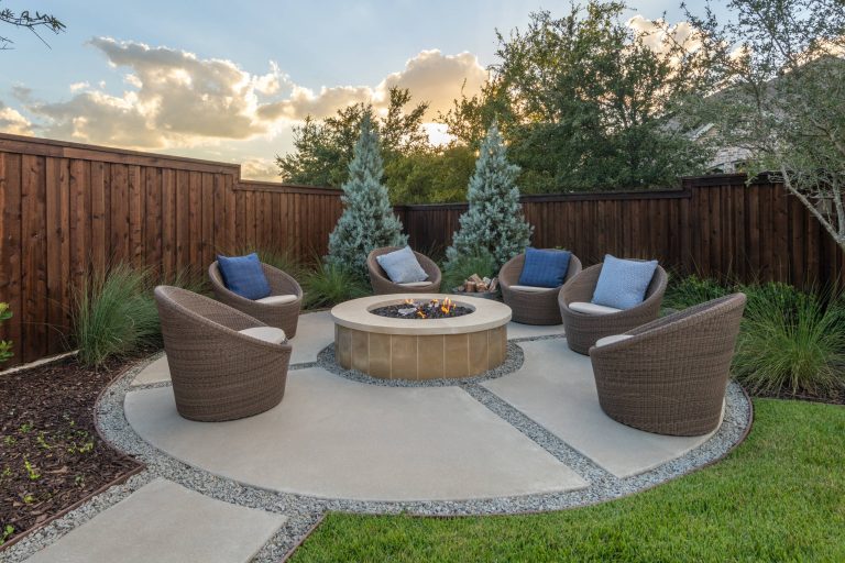 Inspiration for a large transitional backyard concrete patio remodel in Dallas with a fire pit and no cover