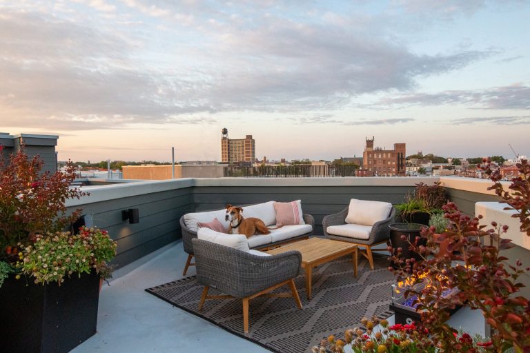 Transitional rooftop deck photo in Philadelphia with a fire pit and no cover