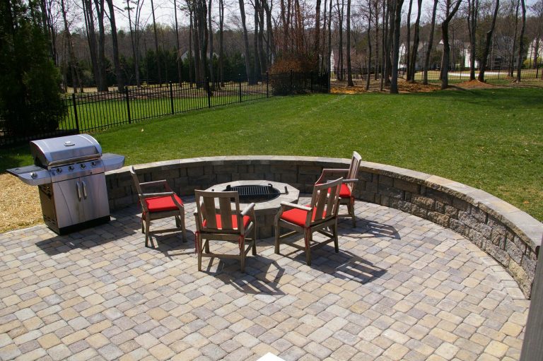 Mid-sized elegant backyard brick patio photo in Charlotte with a fire pit and no cover