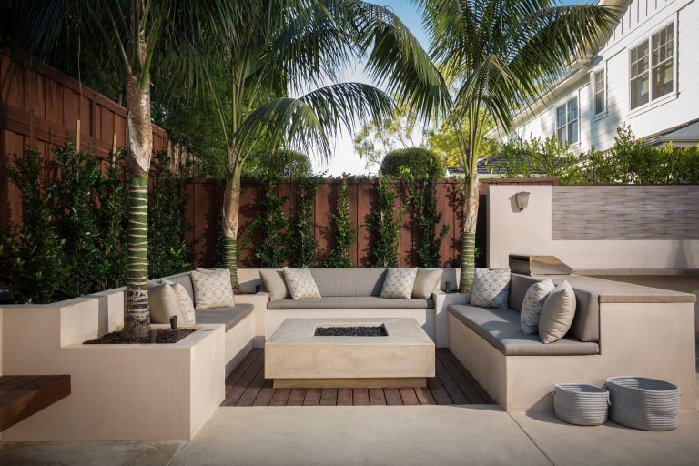 Patio - large modern backyard concrete patio idea in Orange County with a fire pit and no cover