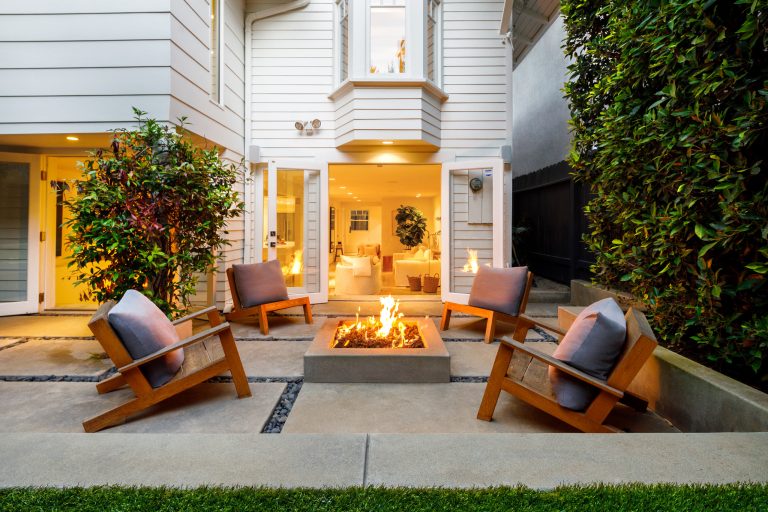 Example of a trendy concrete patio design in Los Angeles with a fire pit and no cover