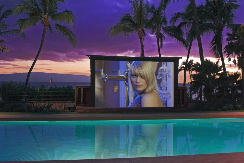 As featured above the fold of the New York Times Home section, this tropical paradise features an outdoor home theater with a 20 ft. screen that unfurls from a water-tight teak bench at the side of the pool and retracts automatically when weather station instruments detects rain or high winds. Kick back with a mai tai while watching the sun set over the ocean and then enjoy a film on the big screen in the open air. The good life! - See more at: http://www.engenv.com/#pproject.php?prj=18