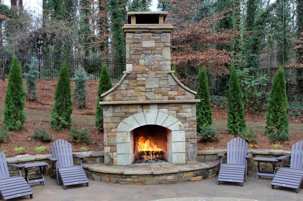 This is a Tennessee stack stone fireplace. We used Ashlar cut and broken stack pieces. The Hearth band was a specially selected Tennessee crab orchard stone. The landscaping is new in the winter. by Artistic Landscapes | Fire Pits|Backyard Design|Outdoor Living Spaces|Landscape Design|Backyard Ideas|Landscaping|Landscaping Ideas|Landscape Installation|Fire Feautures|Fire Pit