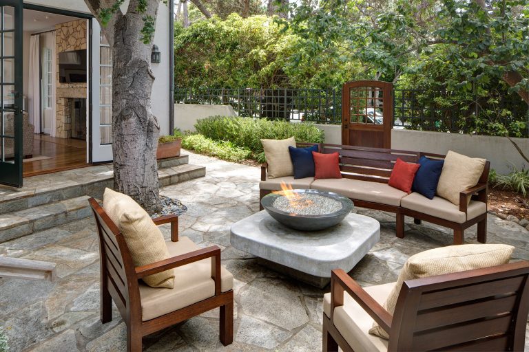 Large transitional backyard stone patio photo in Other with a fire pit