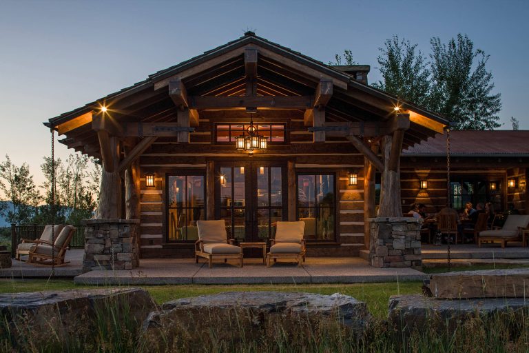 Example of a mid-sized mountain style backyard concrete patio design in Other with a roof extension and a fire pit