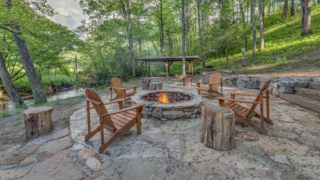Design ideas for a mid-sized rustic backyard stone landscaping in Atlanta with a fire pit.