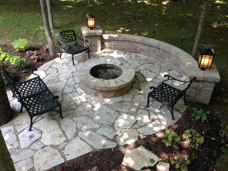 This stunning flagstone patio in Salt Lake features a gorgeous outdoor fire pit with a built in paver sitting wall for maximum seating.