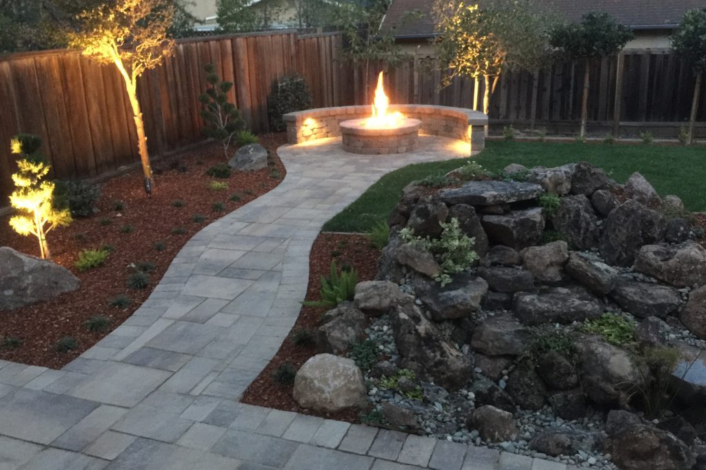 Outdoor firepit with natural gas. Calstone pavers and Roman Stone custom built with 24" gas ring in 36" pit.