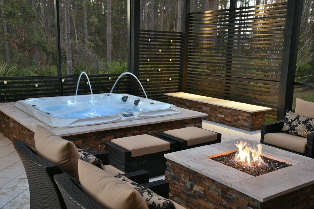 Mid-sized island style backyard tile patio photo in Jacksonville with a fire pit and a pergola