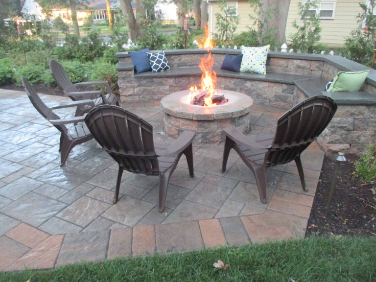 Example of a large classic backyard stone patio design in New York with a fire pit and no cover