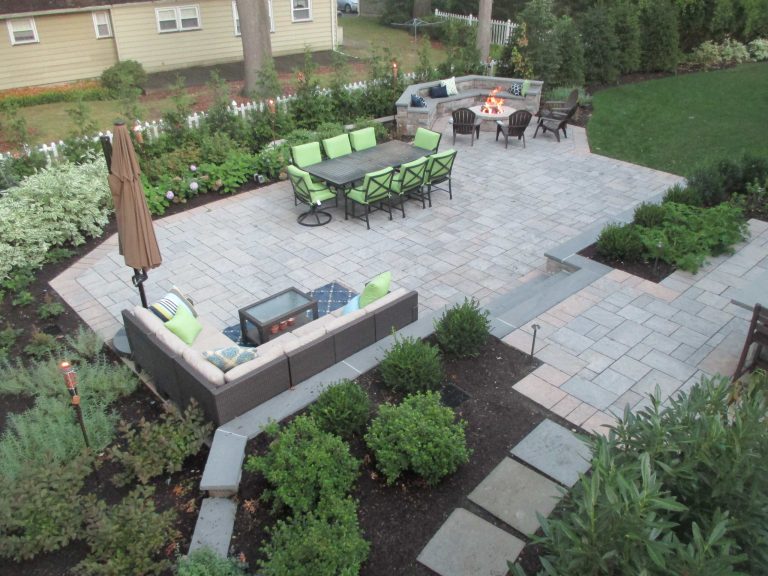 Inspiration for a large timeless backyard stone patio remodel in New York with a fire pit and no cover