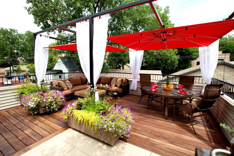 This Small Chicago Garage rooftop is a typical size for the city, but the new digs on this garage are like no other. With custom Molded planters by CGD, Aog grill, FireMagic fridge and accessories, Imported Porcelain tiles, IPE plank decking, Custom Steel Pergola with the look of umbrellas suspended in mid air. and now this space and has been transformed from drab to FAB!