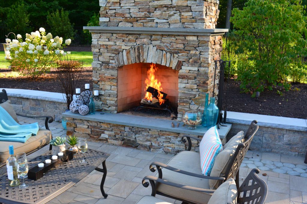Example of a large arts and crafts backyard concrete paver patio design in Richmond with a fire pit and no cover