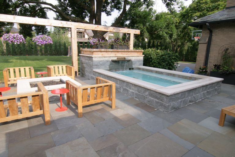 This "home in the city" wanted a multifunctional pool/spa, so David Kopfmann with Yardscapes created this large spa that could be used as either. He incorporated it into a bluestone patio, along side a wood fire pit. by yardscapes Inc. | Pool design | Pool Contracting | Swimming Pool Ideas | Swimming Pool Design Ideas