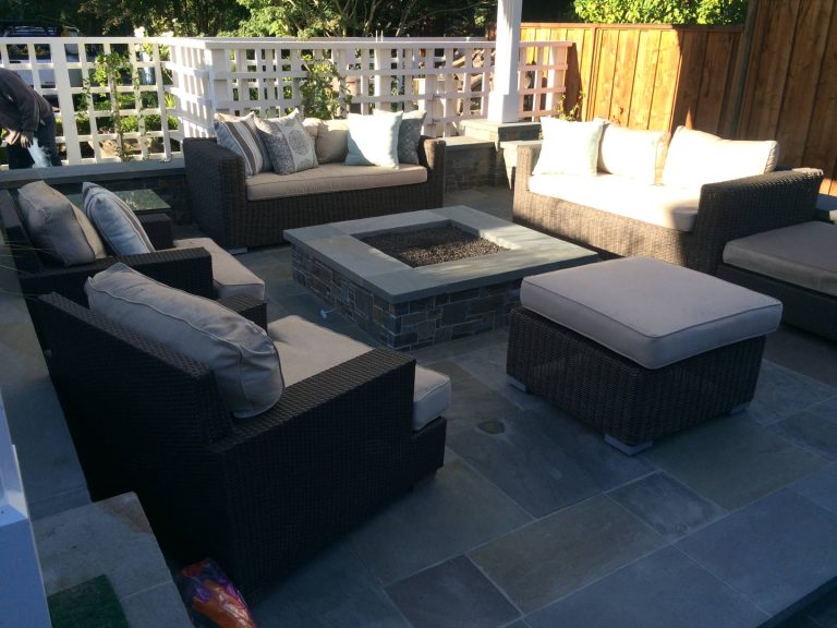 Inspiration for a large contemporary backyard stamped concrete patio remodel in Other with a fire pit and a roof extension