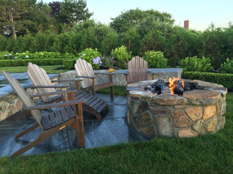stone veneer firepit with irregular capstones. Granite terrace